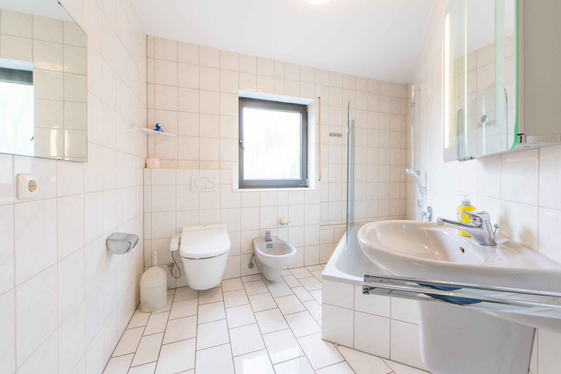 Hauptbad auf der EG Ebene mit Tageslicht, WC, Badewanne und Waschtisch - Oliver Reifferscheid - Immobilienmakler Darmstadt